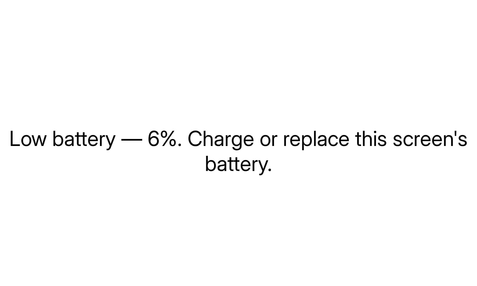 A Lobby e-ink display showing a small notice asking for its battery to be charged